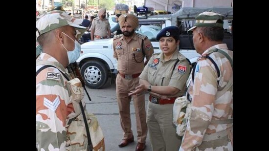 Khanna SSP Amneet Kondal interacting with police officials during a flag march held in the city on Tuesday. (HT photo)