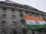 People show an Indian flag from the roof of the Indian High Commission as protestors of the Khalistan movement demonstrate on the streets in London.