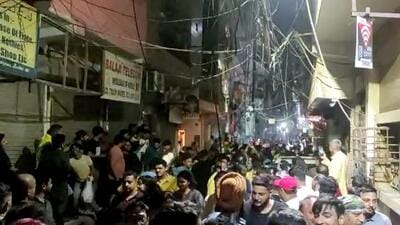 *People gather after a building tilts following an earthquake, at Shakarpur area in New Delhi. (PTI)