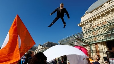 French workers who are on strike toss a puppet depicting French President Emmanuel Macron, during a demonstration on the eve of the ninth day of national strike and protests. in Nice, France, March 22. (Eric Gaillard / REUTERS) French workers who are on strike toss a puppet depicting French President Emmanuel Macron, during a demonstration on the eve of the ninth day of national strike and protests. in Nice, France, March 22. (Eric Gaillard / REUTERS)