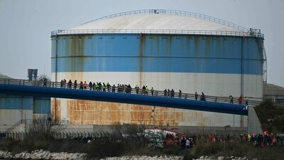 Oil worker protest outside the refinery after the government announced the first requisition of oil workers since the beginning of the strikes against the pension reform, at the Fos-sur-Mer depot near Marseille on March 21. Oil shipments in the country were partially disrupted amid strikes at several refineries in western and southern France. (Christophe Simon / AFP) Oil worker protest outside the refinery after the government announced the first requisition of oil workers since the beginning of the strikes against the pension reform, at the Fos-sur-Mer depot near Marseille on March 21. Oil shipments in the country were partially disrupted amid strikes at several refineries in western and southern France. (Christophe Simon / AFP)