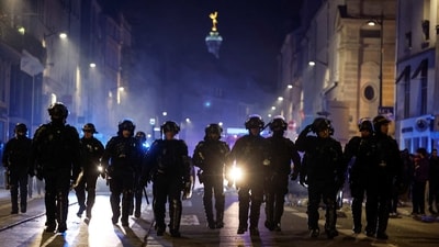 Police in riot gear patrol the street during a demonstration in Paris, France, on March 21. (Gonzalo Fuentes / REUTERS) Police in riot gear patrol the street during a demonstration in Paris, France, on March 21. (Gonzalo Fuentes / REUTERS)