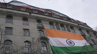 People show an Indian flag from the roof of the Indian High Commission as protestors of the Khalistan movement demonstrate on the streets in London. (AP) People show an Indian flag from the roof of the Indian High Commission as protestors of the Khalistan movement demonstrate on the streets in London. (AP)