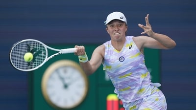 FILE - Iga Swiatek of Poland returns a shot from Naomi Osaka of Japan during the women's singles finals of the Miami Open tennis tournament, Saturday, April 2, 2022, in Miami Gardens, Fla. Defending champion Iga Swiatek has pulled out of the Miami Open because of a rib injury. The No. 1-ranked Swiatek was supposed to face Claire Liu in the second round on Thursday, March 23, 2023. (AP Photo/Wilfredo Lee, File) (AP) FILE - Iga Swiatek of Poland returns a shot from Naomi Osaka of Japan during the women's singles finals of the Miami Open tennis tournament, Saturday, April 2, 2022, in Miami Gardens, Fla. Defending champion Iga Swiatek has pulled out of the Miami Open because of a rib injury. The No. 1-ranked Swiatek was supposed to face Claire Liu in the second round on Thursday, March 23, 2023. (AP Photo/Wilfredo Lee, File) (AP)