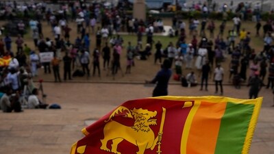 Sri Lanka Economic Crisis: A Sri Lankan flag is waved by a protester. (AP)