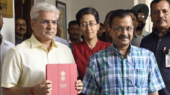 Delhi chief minister Arvind Kejriwal with finance minister Kailash Gahlot at Delhi Legislative Assembly in New Delhi on Wednesday. (Sanjeev Verma/HT Photo)