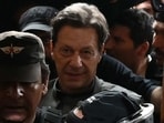Pakistan's former prime minister Imran Khan (C) leaves after appearing before a court for a protective bail in relation to two cases, in Lahore on March 21, 2023. (AFP)