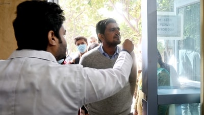 A health worker collects a swab sample for Covid-19 test at the District Hospital in Noida. (Hindustan Times) A health worker collects a swab sample for Covid-19 test at the District Hospital in Noida. (Hindustan Times)
