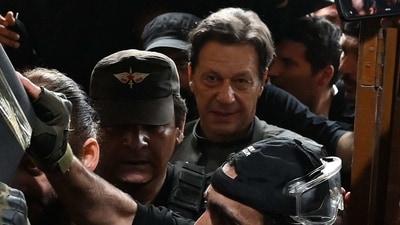 Pakistan's former prime minister Imran Khan (C) leaves after appearing before a court for a protective bail in relation to two cases, in Lahore on March 21, 2023. (AFP)