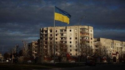 A Ukrainian national flag flutters near the buildings destroyed by Russian military strike, amid Russia's invasion of Ukraine, in the town of Borodianka in Kyiv. (Reuters)