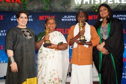 Guneet Monga and Kartiki Gonsalves with the subjects of the Oscar-winning documentary, Bomman and Bellie.
