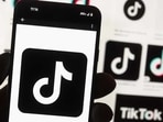 The TikTok logo is seen on a cell phone.