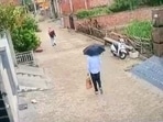 The latest CCTV footage shows Amtitpal Singh in a shirt and pants walking in a residential area in Haryana with an umbrella over his head.