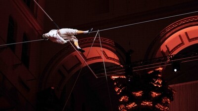 Philippe Petit performs "Wonder on the Wire" above diners during a fundraiser at the National Building Museum on March 23. Petit says he keeps plans for possible tight-rope locations, "extraordinary places, canyons, icebergs, and incredible buildings" &nbsp;stored in a box at his home in New York state, where he has lived for decades. From childhood, "I started not following the lead of authority," he said, describing how he climbed everywhere -- on kitchen chairs, in the trees, reported AFP. (Brendan Smialowski / AFP)