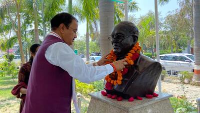 Deputy chief minister Keshav Prasad Maurya garlanding the bust of Dr BR Ambedkar at BBAU on Friday. (HT Photo)