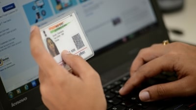 By linking the Aadhaar card to the ration card, the government will be able to prevent individuals from obtaining multiple ration cards. (Mint) By linking the Aadhaar card to the ration card, the government will be able to prevent individuals from obtaining multiple ration cards. (Mint)
