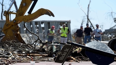 A damaged street sign is seen as workers clear damage from a series of powerful storms and tornado in Mississippi. (Getty Images via AFP) A damaged street sign is seen as workers clear damage from a series of powerful storms and tornado in Mississippi. (Getty Images via AFP)