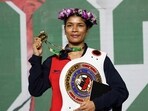 Nikhat Zareen poses for a photo with her belt and the gold medal
