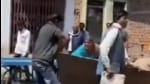 A video went viral on social media of an elderly woman running half-naked pleading with the officials not to take her household items (Twitter/videoscreengrab)