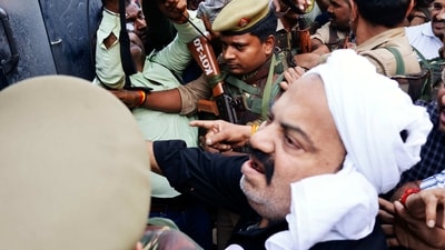 Mafia-turned-politician Atiq Ahmed (in white headgear) steps out of Sabarmati jail as a team of Prayagraj Police takes him with them in Ahmedabad on Sunday. (ANI Photo) Mafia-turned-politician Atiq Ahmed (in white headgear) steps out of Sabarmati jail as a team of Prayagraj Police takes him with them in Ahmedabad on Sunday. (ANI Photo)