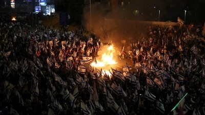 People attend a demonstration after Israeli Prime Minister Benjamin Netanyahu dismissed the defense minister and his nationalist coalition government presses on with its judicial overhaul, in Tel Aviv, Israel, Sunday. (REUTERS)