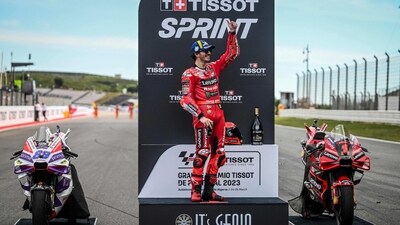 First-placed Ducati Italian rider Francesco Bagnaia celebrates on the podium after the sprint race of the MotoGP Portuguese Grand Prix (AFP)