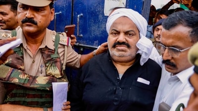Prayagraj Police with jailed-mafia Atiq Ahmed outside Sabarmati Central Jail as he is being shifted to Prayagraj, in Ahmedabad, on Sunday, (PTI) Prayagraj Police with jailed-mafia Atiq Ahmed outside Sabarmati Central Jail as he is being shifted to Prayagraj, in Ahmedabad, on Sunday, (PTI)