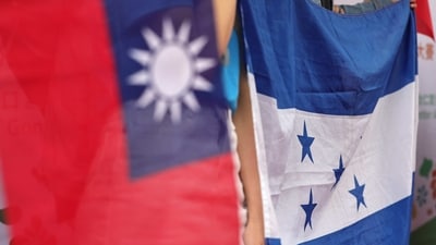 People hold national flags of Honduras and Taiwan during a gathering. (Reuters)