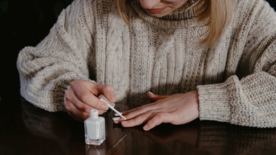 Apply Nail Polish: Apply a base coat to protect your nails and help the nail polish adhere better. Then, apply two coats of your chosen nail polish color, allowing each coat to dry in between. Finish with a topcoat to seal and protect your manicure. (Unsplash) Apply Nail Polish: Apply a base coat to protect your nails and help the nail polish adhere better. Then, apply two coats of your chosen nail polish color, allowing each coat to dry in between. Finish with a topcoat to seal and protect your manicure. (Unsplash)