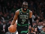 Boston Celtics guard Jaylen Brown (7) dribbles the ball against the San Antonio Spurs during the third quarter at the TD Garden.