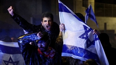 A protestor seen at a demonstration against Israeli Prime Minister Benjamin Netanyahu after he dismissed the defense minister Yaov Gallant, in Jerusalem, March 26. Netanyahu's government, a coalition between his Likud party and extreme-right and ultra-Orthodox allies, has argued the changes are needed to rebalance powers between lawmakers and the judiciary. (Ronen Zvulun / REUTERS) A protestor seen at a demonstration against Israeli Prime Minister Benjamin Netanyahu after he dismissed the defense minister Yaov Gallant, in Jerusalem, March 26. Netanyahu's government, a coalition between his Likud party and extreme-right and ultra-Orthodox allies, has argued the changes are needed to rebalance powers between lawmakers and the judiciary. (Ronen Zvulun / REUTERS)