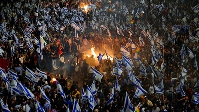 Israelis opposed to Netanyahu's judicial overhaul plan seen setting up bonfires and blocking a highway after Gallant's dismissal, on March 26. Gallant had called on Netanyahu to freeze the plan, citing deep divisions in the country and turmoil in the military. (Ohad Zwigenberg / AP) Israelis opposed to Netanyahu's judicial overhaul plan seen setting up bonfires and blocking a highway after Gallant's dismissal, on March 26. Gallant had called on Netanyahu to freeze the plan, citing deep divisions in the country and turmoil in the military. (Ohad Zwigenberg / AP)