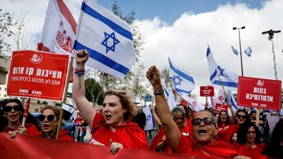 Women dressed as handmaidens from "The Handmaid's Tale" seen at a demonstration in Jerusalem, on March 27. Israel's top trade union chief had Monday called a general strike, according to AFP. The Israel Medical Association quickly followed suit, announcing “a full strike in the health system”. (Ammar Awad / REUTERS) Women dressed as handmaidens from "The Handmaid's Tale" seen at a demonstration in Jerusalem, on March 27. Israel's top trade union chief had Monday called a general strike, according to AFP. The Israel Medical Association quickly followed suit, announcing “a full strike in the health system”. (Ammar Awad / REUTERS)