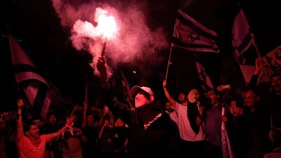 Israelis seen blocking a highway in Tel Aviv, on March 27. About 600,000-700,000 Israelis joined the demonstrations across the country, PTI reported. Protesters in Tel Aviv lit large bonfires, while police scuffled with those who gathered outside Netanyahu's private home in Jerusalem. (Ohad Zwigenberg / AP) Israelis seen blocking a highway in Tel Aviv, on March 27. About 600,000-700,000 Israelis joined the demonstrations across the country, PTI reported. Protesters in Tel Aviv lit large bonfires, while police scuffled with those who gathered outside Netanyahu's private home in Jerusalem. (Ohad Zwigenberg / AP)