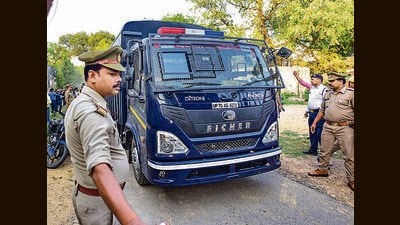 A van carrying Atiq Ahmed arrives at Naini Central jail in Prayagraj on Monday. (PTI) A van carrying Atiq Ahmed arrives at Naini Central jail in Prayagraj on Monday. (PTI)