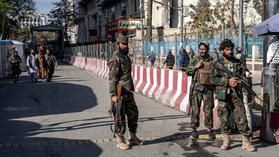 Taliban fighters stand guard at the explosion site, near the Foreign Ministry in Kabul. (AP) Taliban fighters stand guard at the explosion site, near the Foreign Ministry in Kabul. (AP)