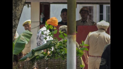An alleged associate (in orange turban) of 'Waris Punjab De' Chief Amritpal Singh being brought to central jail, in Dibrugarh. (PTI Photo) An alleged associate (in orange turban) of 'Waris Punjab De' Chief Amritpal Singh being brought to central jail, in Dibrugarh. (PTI Photo)
