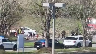 In this image from video provided by Jozen Reodica, law enforcement officers lead children away from the scene of a shooting at The Covenant School, a private Christian school in Nashville, Tenn., on Monday March 27, 2023. (AP) In this image from video provided by Jozen Reodica, law enforcement officers lead children away from the scene of a shooting at The Covenant School, a private Christian school in Nashville, Tenn., on Monday March 27, 2023. (AP)
