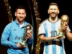 Argentina's Lionel Messi poses with a statue of himself holding the World Cup during the Conmebol event. 