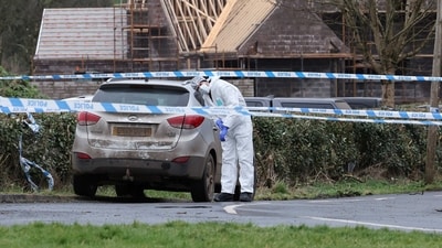 A forensic officer from Police Service of Northern Ireland (PSNI) works at the scene of the Youth Sport Omagh sports complex on Killyclogher Road area, where off-duty PSNI Detective Chief Inspector John Caldwell was shot, in Omagh, Northern Ireland February 23. (REUTERS)