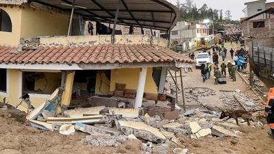 Ecuador Landslide: A rescuer with a sniffer dog search for victims following a landslide in Alausi, Ecuador. (AFP) Ecuador Landslide: A rescuer with a sniffer dog search for victims following a landslide in Alausi, Ecuador. (AFP)