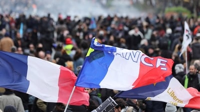 Flags are seen during a demonstration as part of the tenth day of nationwide strikes and protests against French government's pension reform in Paris, France. (REUTERS)