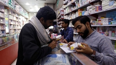 Pakistan Economic Crisis: A customer buys medicine from a medical supply store in Karachi, Pakistan. (Reuters)