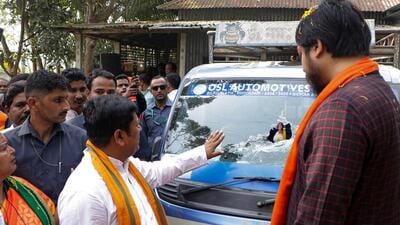 Union MoS Nisith Pramanik and BJP Bengal president Sukanta Majumdar look at a damaged vehicle which was allegedly attacked by rival political group, in Cooch Behar (PTI) Union MoS Nisith Pramanik and BJP Bengal president Sukanta Majumdar look at a damaged vehicle which was allegedly attacked by rival political group, in Cooch Behar (PTI)