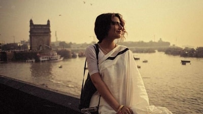 She teamed her saree with a simple white cotton blouse. Adding old-school elements, she paired her look with a black tote bag and a vintage film camera. (Instagram/@fatimasanashaikh) She teamed her saree with a simple white cotton blouse. Adding old-school elements, she paired her look with a black tote bag and a vintage film camera. (Instagram/@fatimasanashaikh)