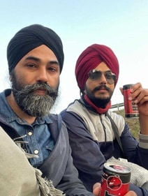 In the picture, it appears that Amritpal Singh and Papalpreet Singh are sitting atop a truck.
