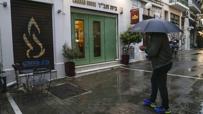 A man holding an umbrella stands in front of a Jewish restaurant that Greek officials believe was one of the targets of a planned terrorist attack, in central Athens, Tuesday. (AP) A man holding an umbrella stands in front of a Jewish restaurant that Greek officials believe was one of the targets of a planned terrorist attack, in central Athens, Tuesday. (AP)