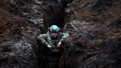 Russia-Ukraine War: A Ukrainian serviceman hides in a trench near the frontline town of Bakhmut amid Russia's attack on Ukraine, Donetsk region. (Reuters)