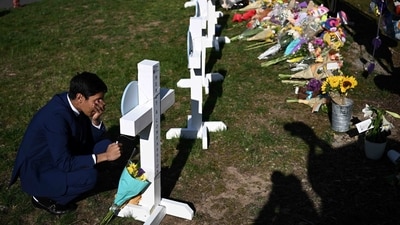 People pay their respects at a makeshift memorial for victims at the Covenant School building at the Covenant Presbyterian Church following the shooting. (AFP) People pay their respects at a makeshift memorial for victims at the Covenant School building at the Covenant Presbyterian Church following the shooting. (AFP)