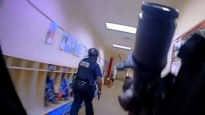 A body camera video shows officers searching room by room for the shooter as a school alarm blared. (Reuters) A body camera video shows officers searching room by room for the shooter as a school alarm blared. (Reuters)